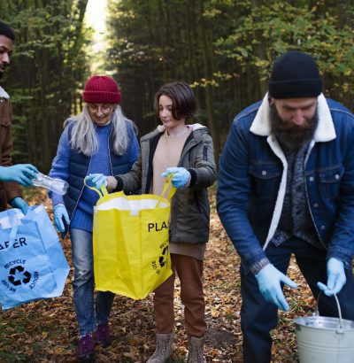 diverse-group-of-volunteers-cleaning-up-forest-from-waste-community-service-concept.jpg